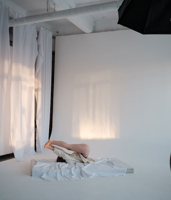 Woman performing a gentle cardio movement in a bright, airy room.